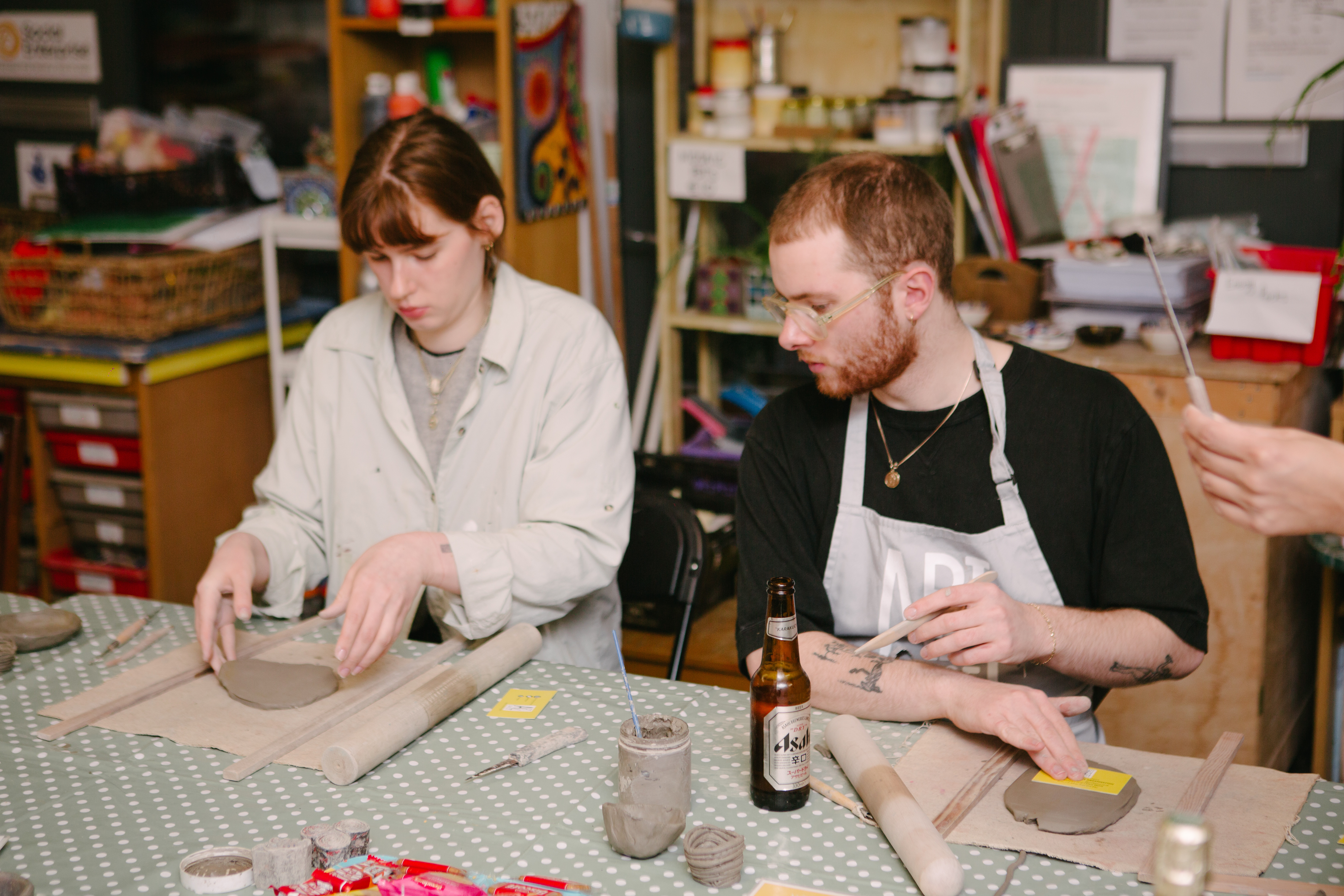 A couple working together at a hand building pottery class